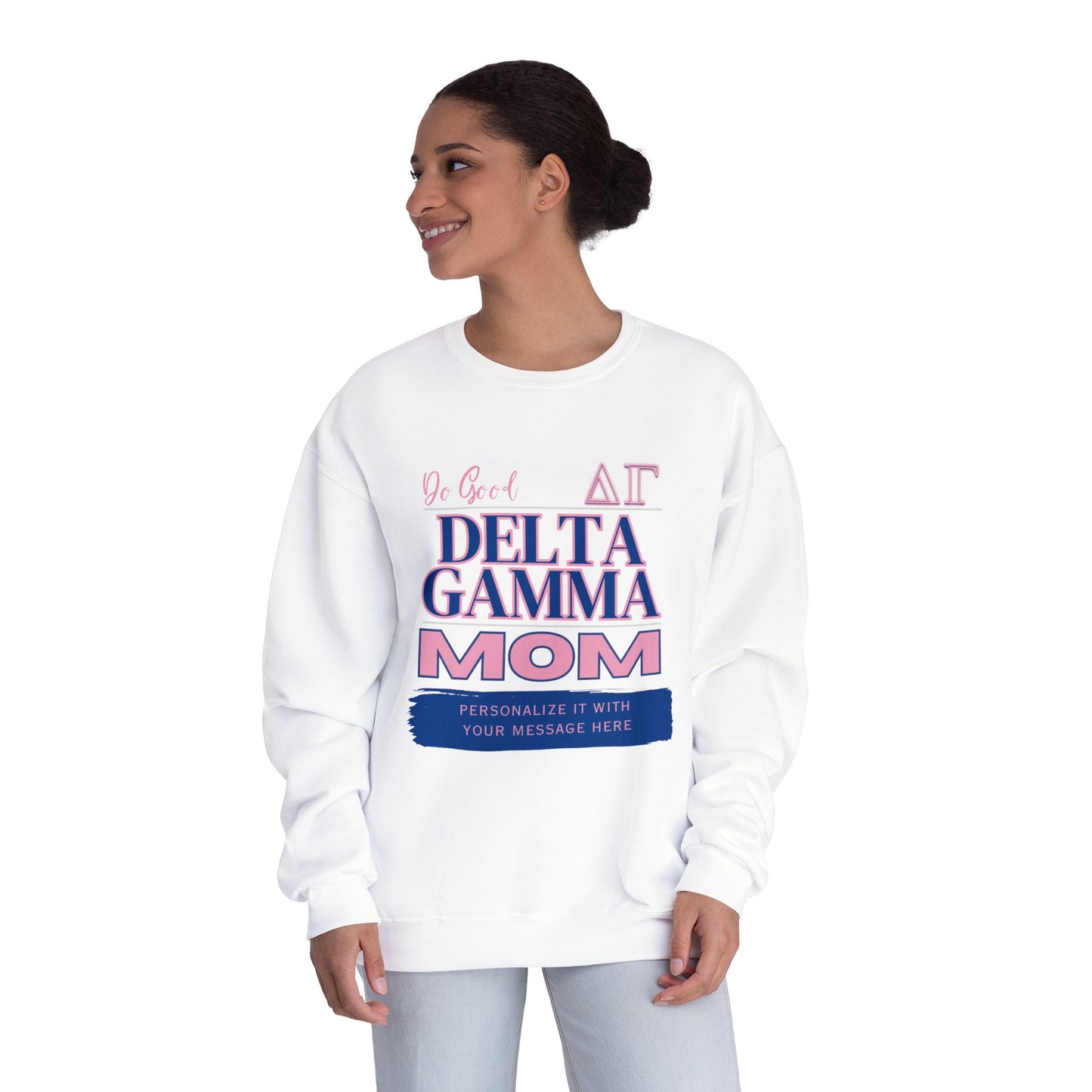 A person wearing a Gifts For Mom white personalizable Delta Gamma Mom sweatshirt set against a plain white background. The words Do Good and the greek symbols are also written on the shirt.