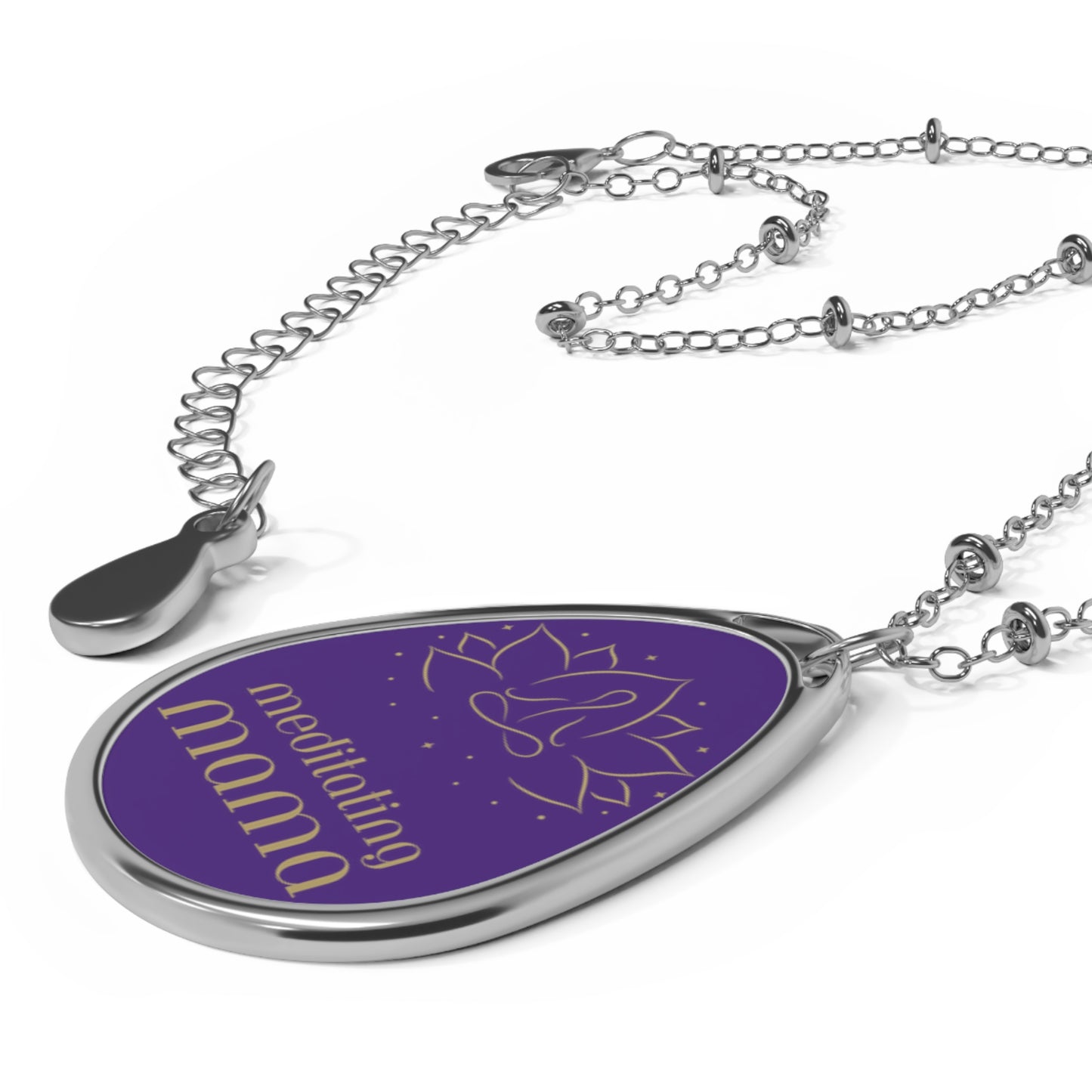 This delicate silver necklace from the Gifts for Mom store showcases a teardrop-shaped pendant with a purple background. It features a simple line drawing of a person meditating, and the words meditating mama beneath it, perfect for the love of meditation.