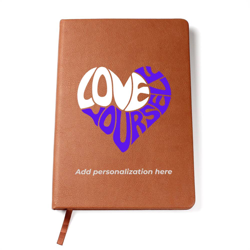A vegan leather journal featuring an engraved heart made up of the word "love" in white and "yourself" in purple. This journal from the Gifts For Mom store is personalizable.