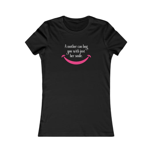 Black t-shirt from the Gifts For Mom store, featuring the text A mother can hug you with just her smile above a simple pink smile graphic. Celebrate mom with this heartfelt design.
