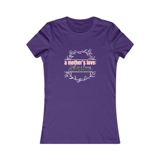 Purple T-shirt with decorative text: a mothers love: soft as a flower, strong as an ox, encircled by a floral wreath design. Available at the Gifts For Mom store and perfect for celebrating mom because she deserves it.